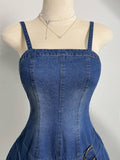 Close-up of medium-wash denim dress square neckline and corset-inspired seams