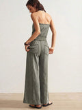 Back view of sage green strapless jumpsuit with elastic waist and rear patch pockets