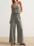 Front view of sage green strapless wide-leg jumpsuit with drawstring waist and utility pockets