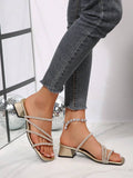 Side view of champagne gold rhinestone mule sandals with metallic footbed