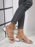 Side view of white square toe crystal mule sandals worn on foot