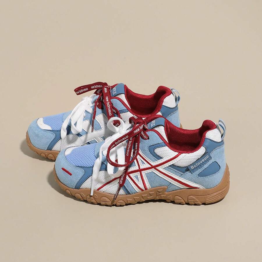 Rear-side view of light blue, white, and red lace-up sneaker with gum sole