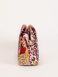 Side view patchwork fabric ruffle clutch pouch showing gathered top puffy body and gold zipper pull