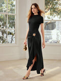 Full front view of black draped maxi dress with gold floral hip detail and overlapping front slit