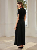Back view of black ankle-length dress with fitted short-sleeve bodice and softly flared skirt