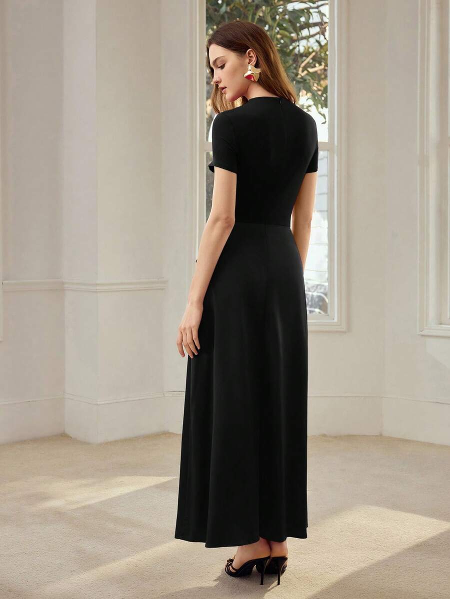 Back view of black ankle-length dress with fitted short-sleeve bodice and softly flared skirt