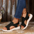 Front side view of black breathable slingback sandals worn with cropped jeans