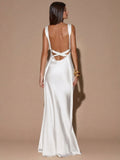 Back view of red sleeveless deep V-neck maxi dress with crossed open back, shown for wedding and evening wear