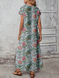 Back view of teal aqua floral maxi dress with center seam