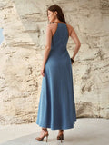 Rear three-quarter view of medium blue sleeveless A-line denim maxi dress with brown trim