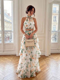 Front view of pastel pink floral halter top and tiered maxi skirt set