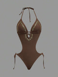 Front studio view of brown halter studded cutout one-piece swimsuit with deep V neckline and hip ties for beach party styling