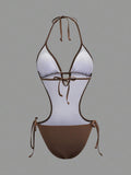 Back studio view of brown halter cutout one-piece swimsuit with open back and tie details for beach party styling