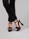 Black glossy bow platform sandal view 4 with open toe and ankle strap