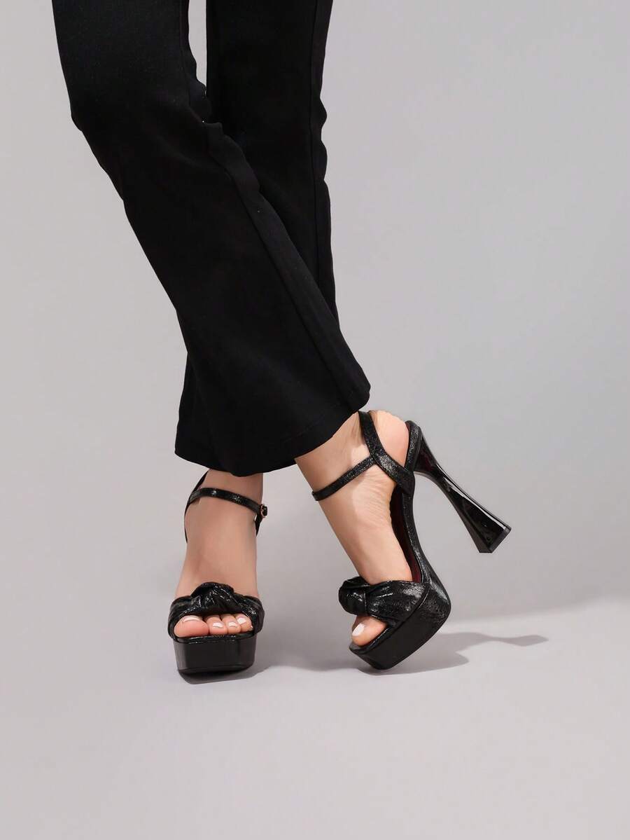 Black glossy bow platform sandal view 4 with open toe and ankle strap