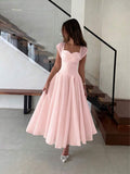 Front Full-Length View of blush pink colorblock A-line midi dress with cap sleeves for wedding guest styling
