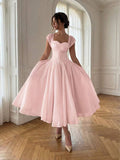 Front View of blush pink colorblock A-line midi dress with cap sleeves for wedding guest styling