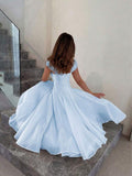 Back View of powder blue colorblock A-line midi dress with cap sleeves for wedding guest styling
