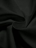 Close-up of black matte knit T-shirt fabric with gathered folds and fine texture
