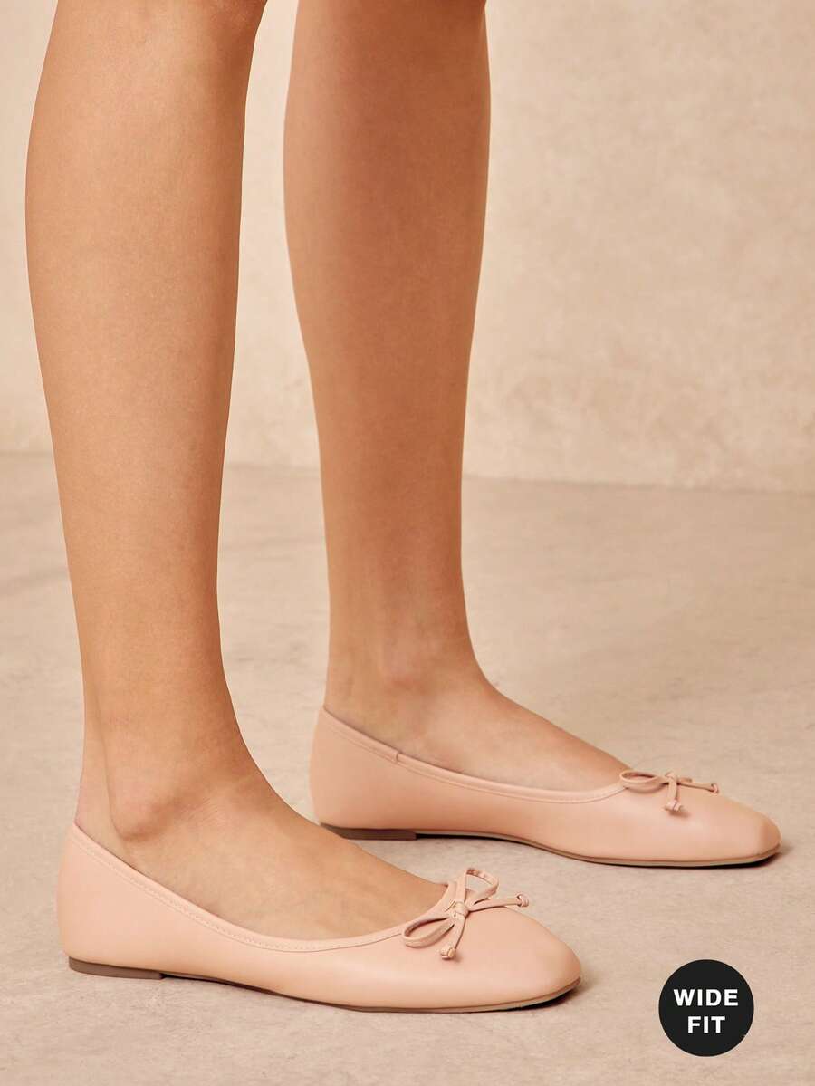 Effortless elegance for every step. These women's wide-fit ballet flats combine timeless design with all-day comfort. The slip-on silhouette means no fussing with laces—just slide in and go. Crafted with a spacious fit that accommodates wider feet without sacrificing style, they're perfect for the office, casual outings, or anywhere you need polished simplicity. Soft, flexible soles adapt to your natural stride, while the classic profile pairs seamlessly with dresses, jeans, or trousers. 