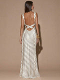 Back view of ivory sleeveless deep V-neck maxi dress with crossed open back, shown for wedding and evening wear