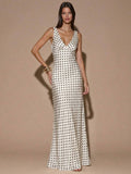 Front view of ivory sleeveless deep V-neck maxi dress with crossed open back, shown for wedding and evening wear