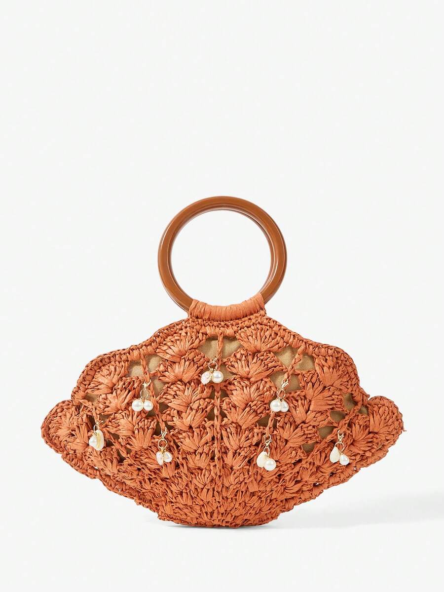 Burnt orange straw shell shaped beach bag with brown handle and pearl shell charms
