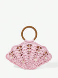 Light pink straw shell shaped beach bag with brown handle and pearl shell charms