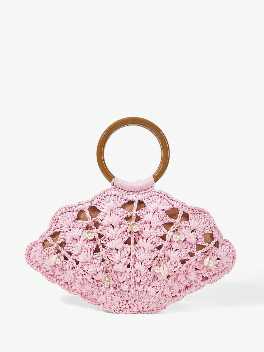 Light pink straw shell shaped beach bag with brown handle and pearl shell charms