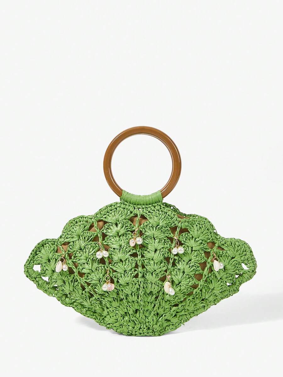 Green straw shell shaped beach bag with brown round handle and pearl shell charms
