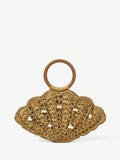 Tan straw shell shaped beach bag with brown round handle and pearl shell charms