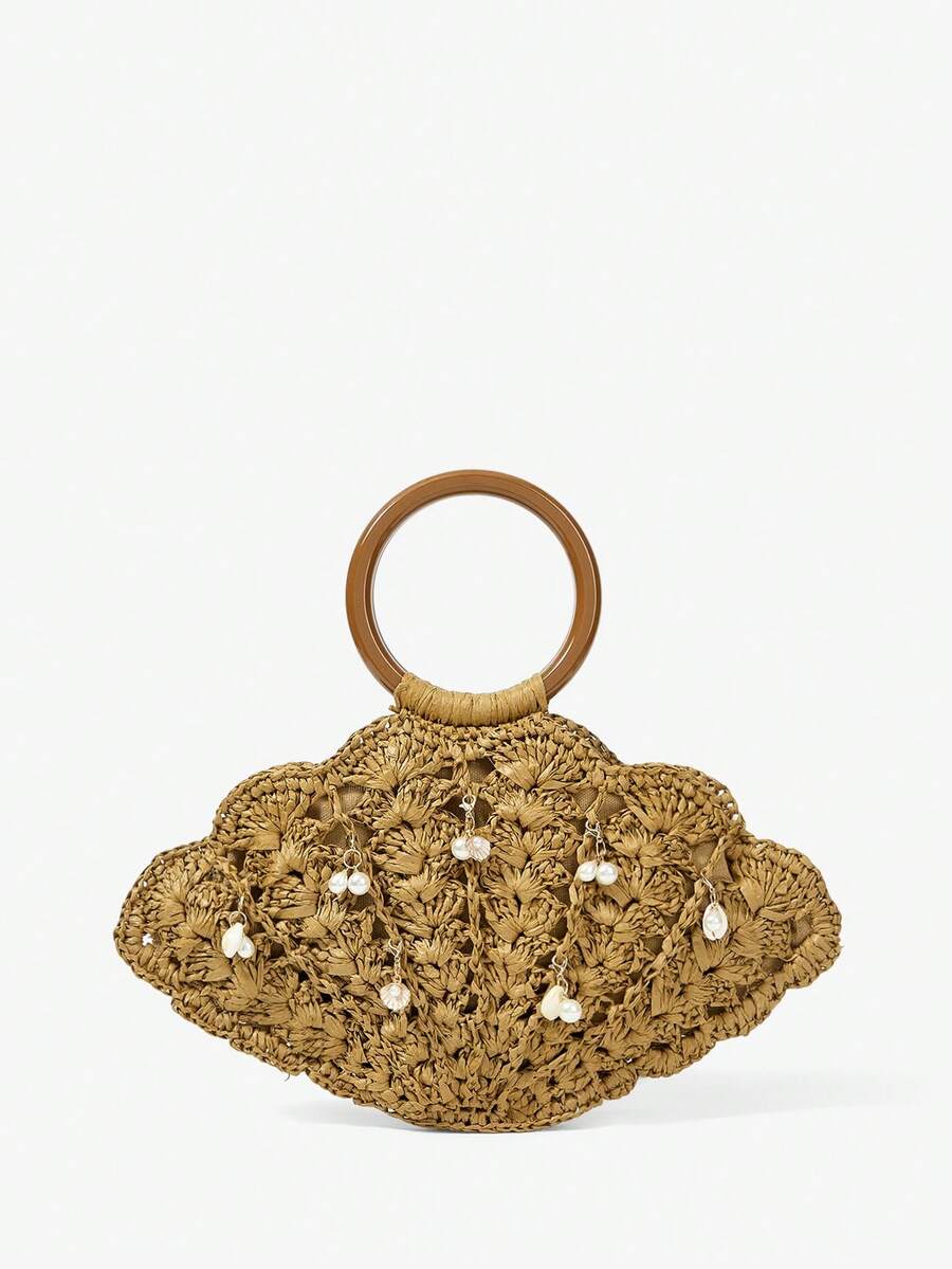 Tan straw shell shaped beach bag with brown round handle and pearl shell charms