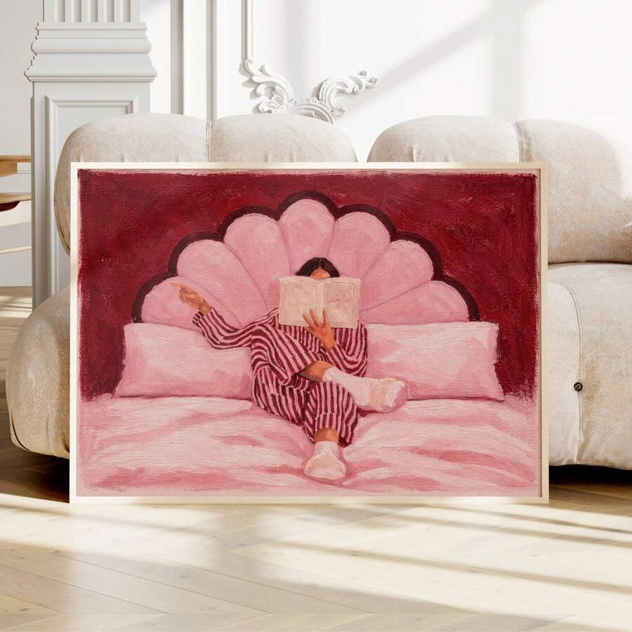 Front view of pink woman reading wall art in an ivory frame before a classic sofa