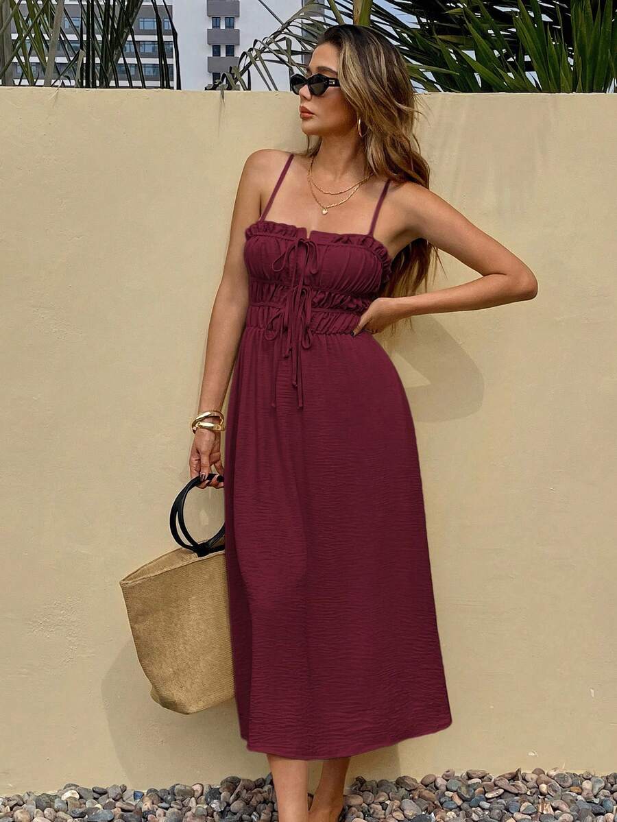 Burgundy tie-front midi sundress with ruffle trim on pebble patio