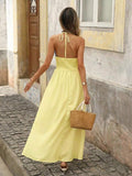 Back view of light yellow boho halter maxi dress with open back and halter tie