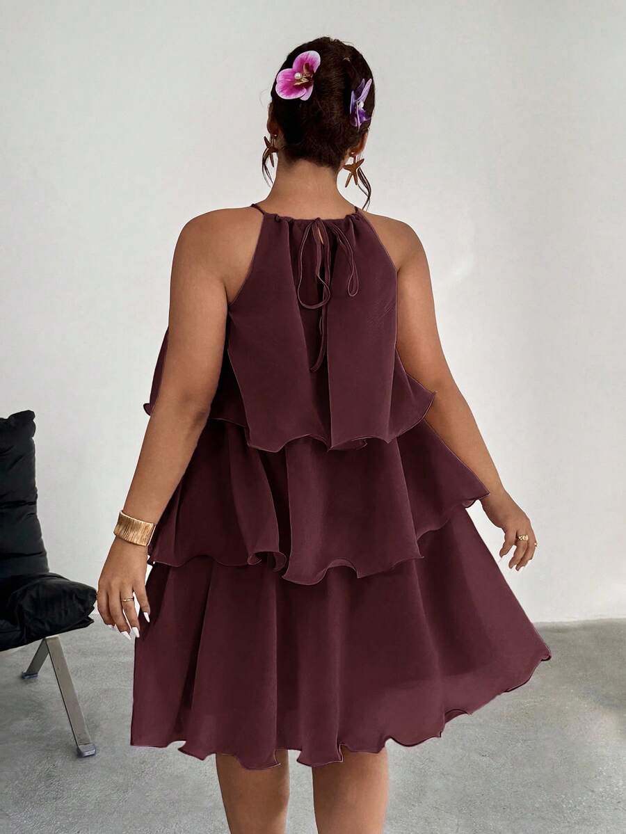 Back view of burgundy tiered halter dress with tie detail