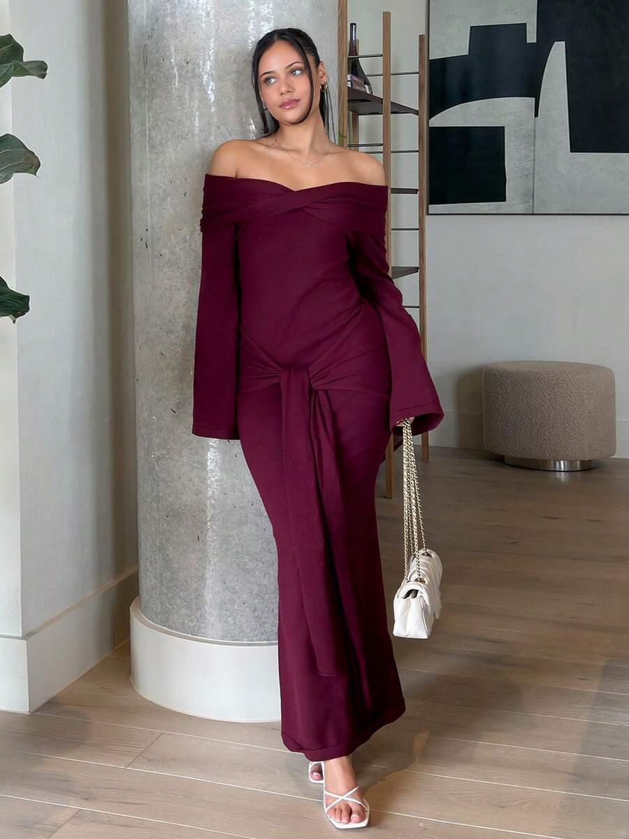 Front view of burgundy off shoulder knit maxi dress with twist bust and front drape tie