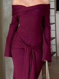 Angled front view of burgundy ribbed knit maxi dress with long flared sleeves
