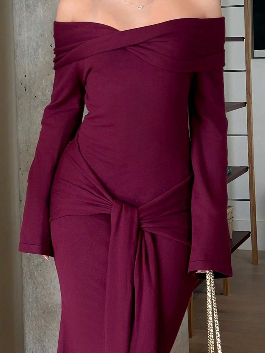 Angled front view of burgundy ribbed knit maxi dress with long flared sleeves