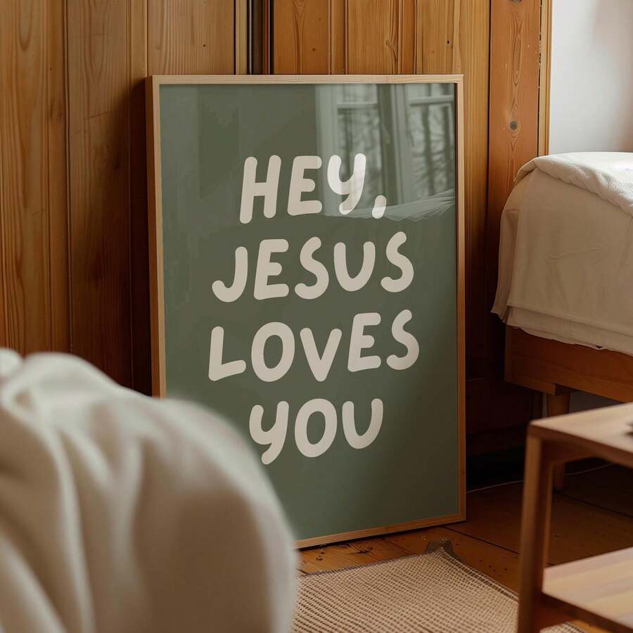Bedroom view of sage green Jesus Loves You canvas wall art in wood frame