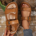 Top view of tan open toe sandals showing contoured footbed and gold buckle detail