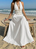 White halter maxi dress with flowing skirt on the beach