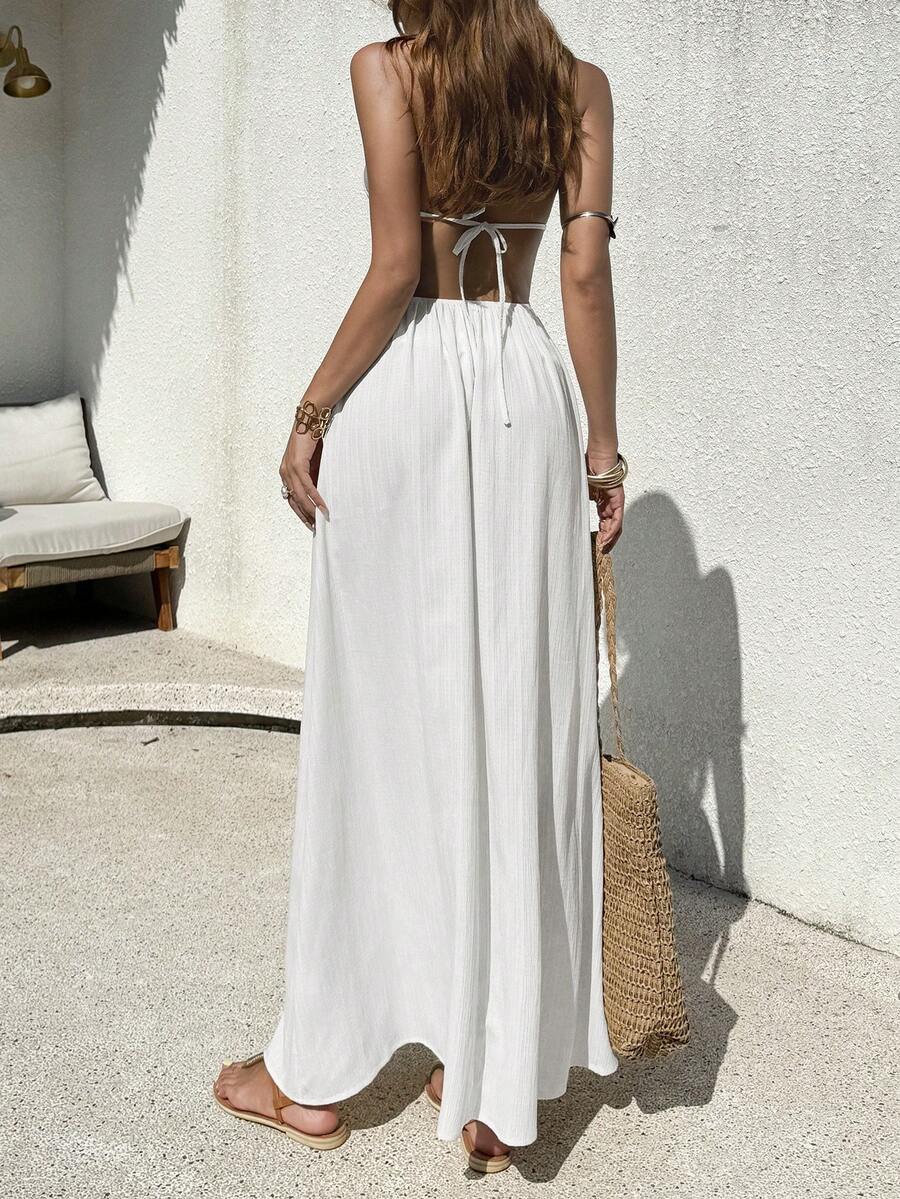 Back view of white halter maxi dress with open back and bow tie