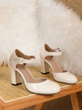 Pair view of cream ankle strap Mary Jane pumps with beige lining