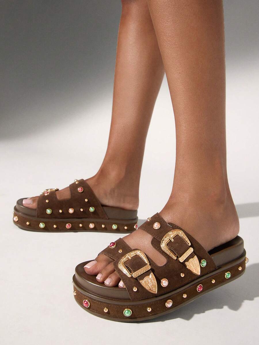 Front three-quarter view of coffee-brown gem-studded platform slide sandals