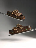 Side profile of backless double-buckle platform slide sandals in studio