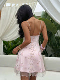Side view of apricot floral embroidered spaghetti strap mini dress with soft side drape