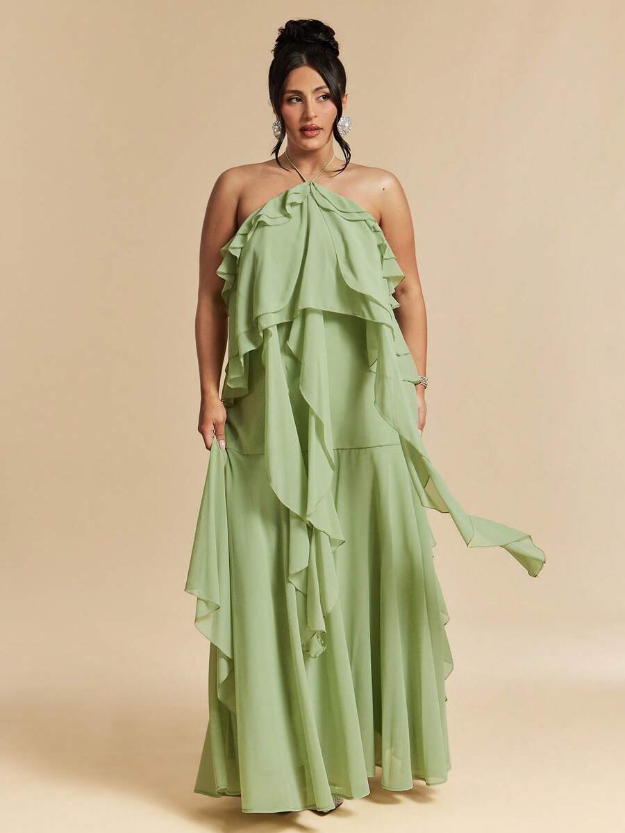 Elevate your wardrobe with this stunning plus-size green halter neck dress, designed for those who embrace elegance and comfort. The flowing maxi silhouette features delicate ruffled details and a flattering tie-back design that creates a graceful, backless look perfect for beach getaways and special celebrations. Crafted from quality woven polyester with a lined interior, this dress offers a polished appearance while maintaining breathability. 