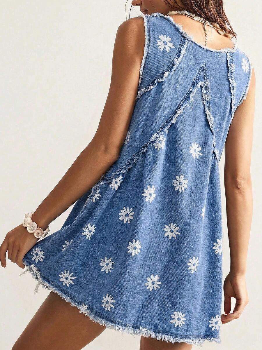 Front model view of faded blue daisy denim mini dress with deep V-neck and frayed hem