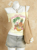 Front mannequin view of pale yellow tropical halter top styled with denim mini skirt
